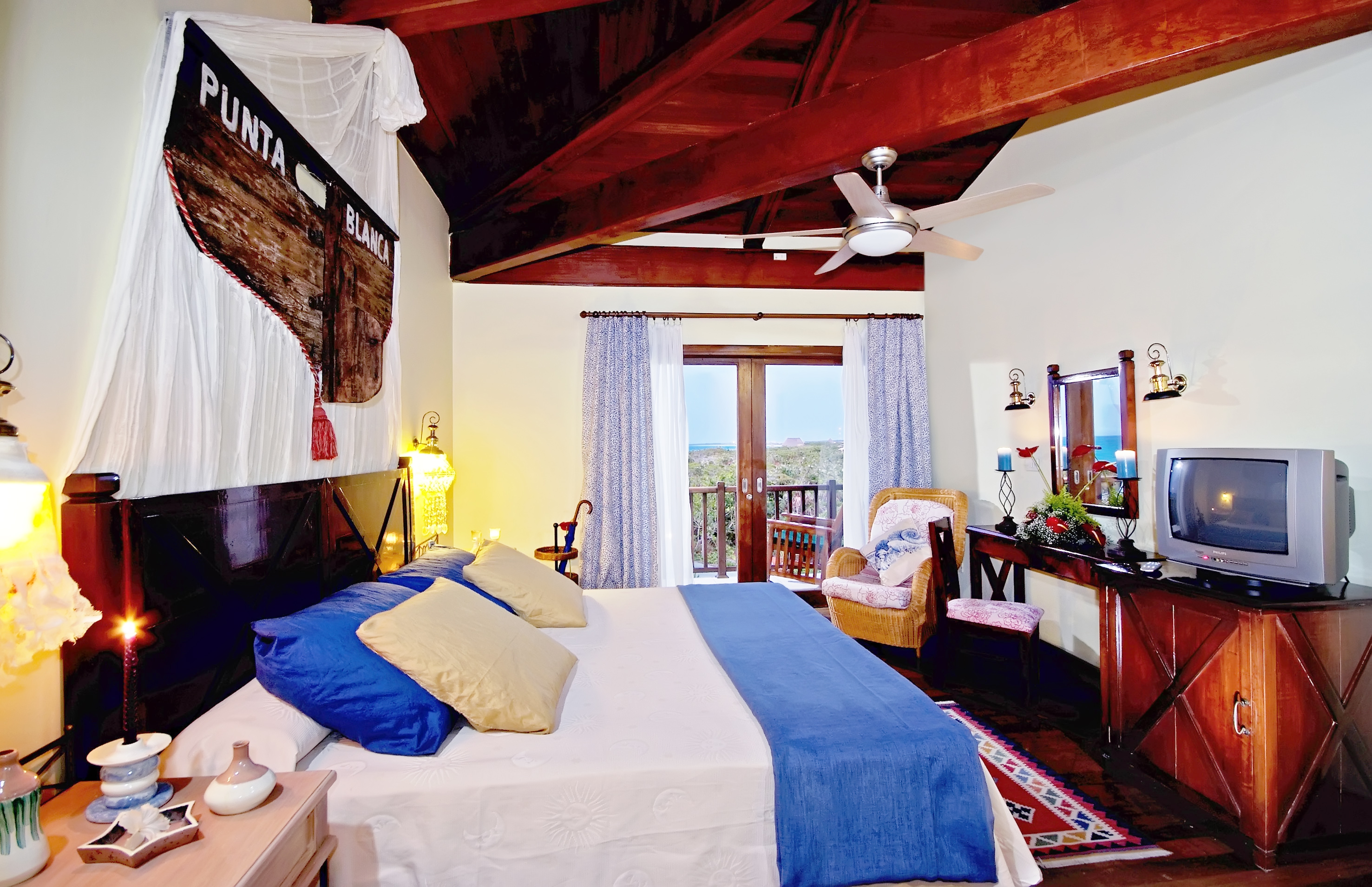 a bedroom with a bed and a table and chairs