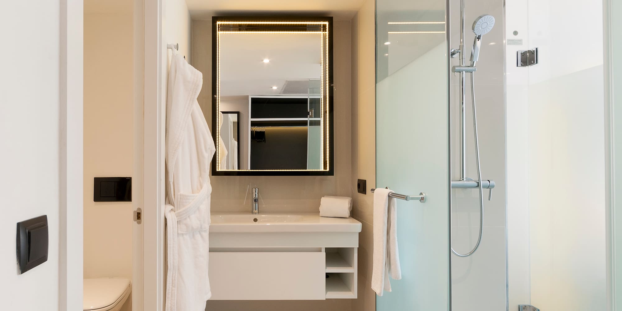 a bathroom with a glass shower and a sink