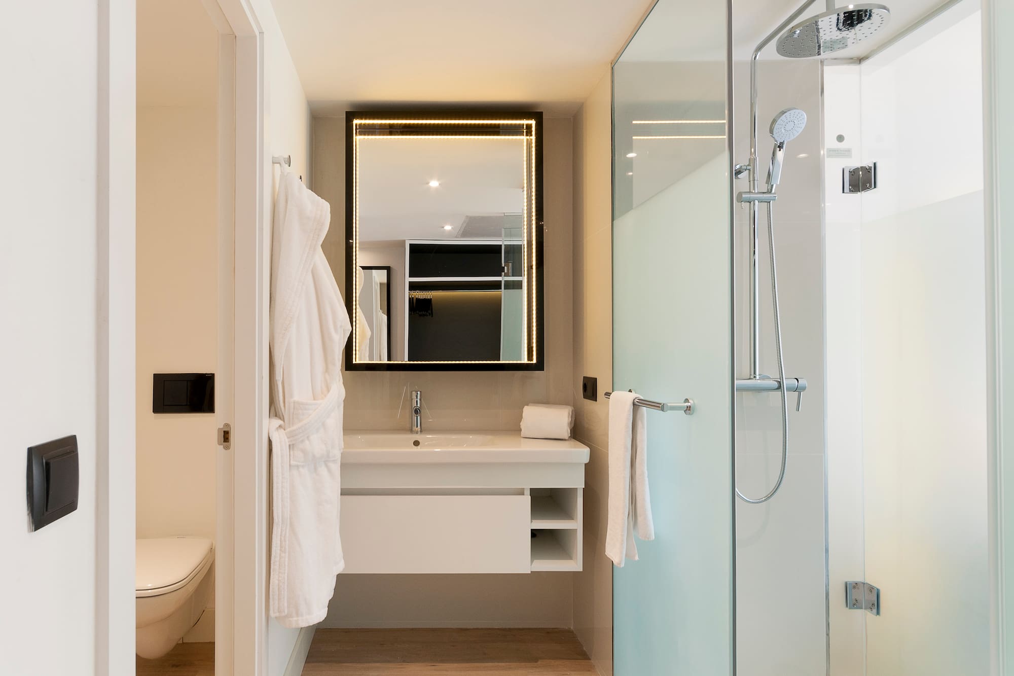 a bathroom with a glass shower and a sink