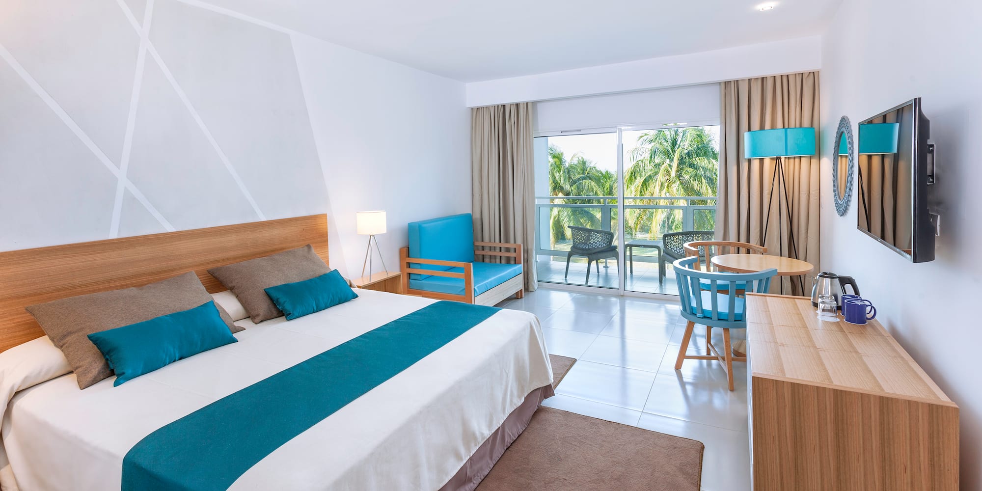 a bedroom with a bed and a table and chairs