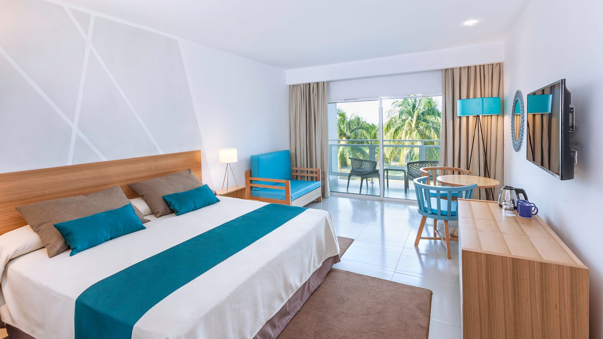 a bedroom with a bed and a table and chairs