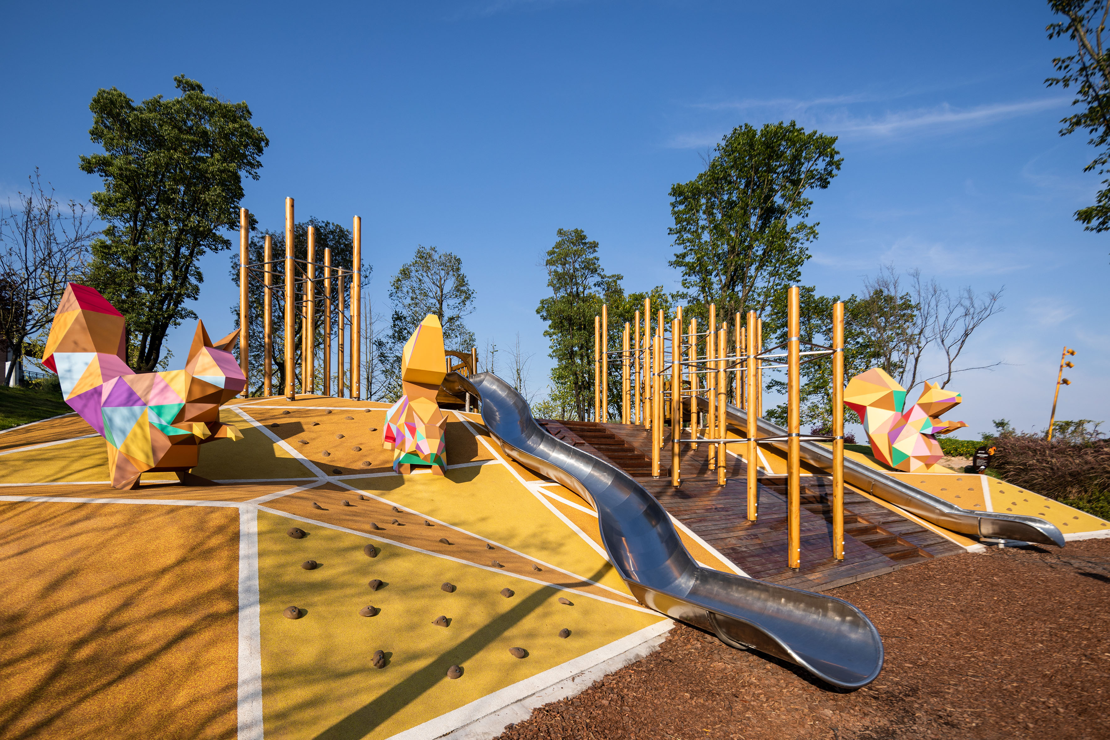 Colorful park playground featuring geometric squirrels, slides, and climbing areas.