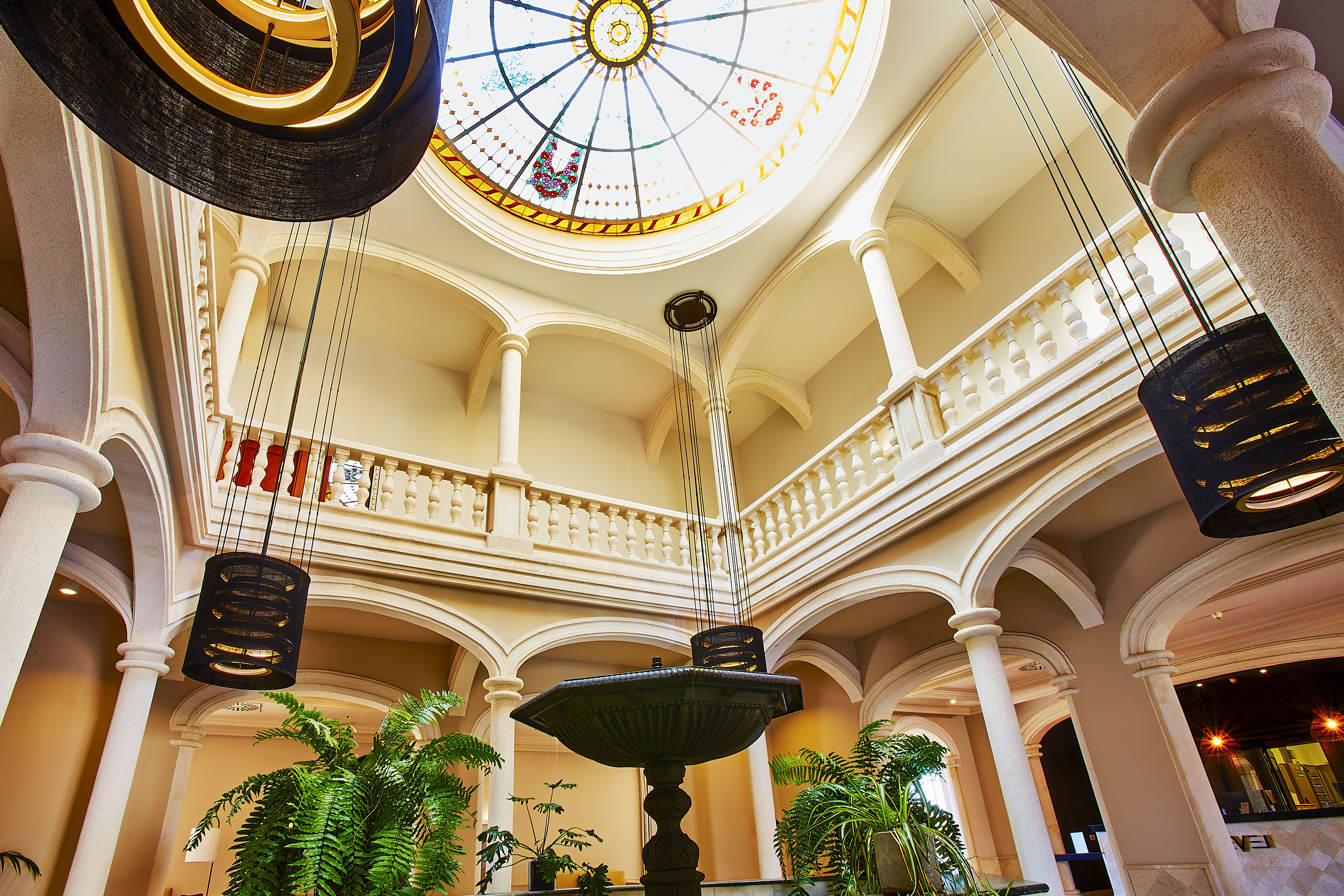 a large room with a stained glass skylight