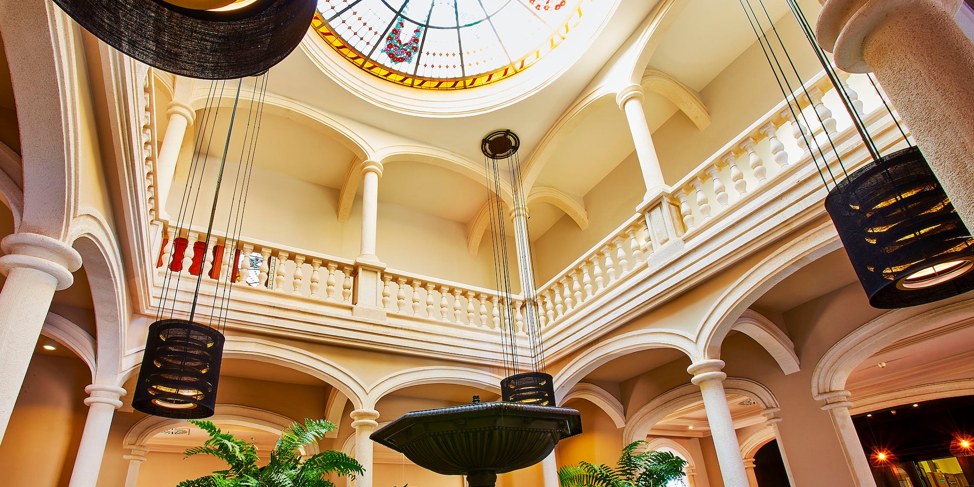 a large room with a stained glass skylight