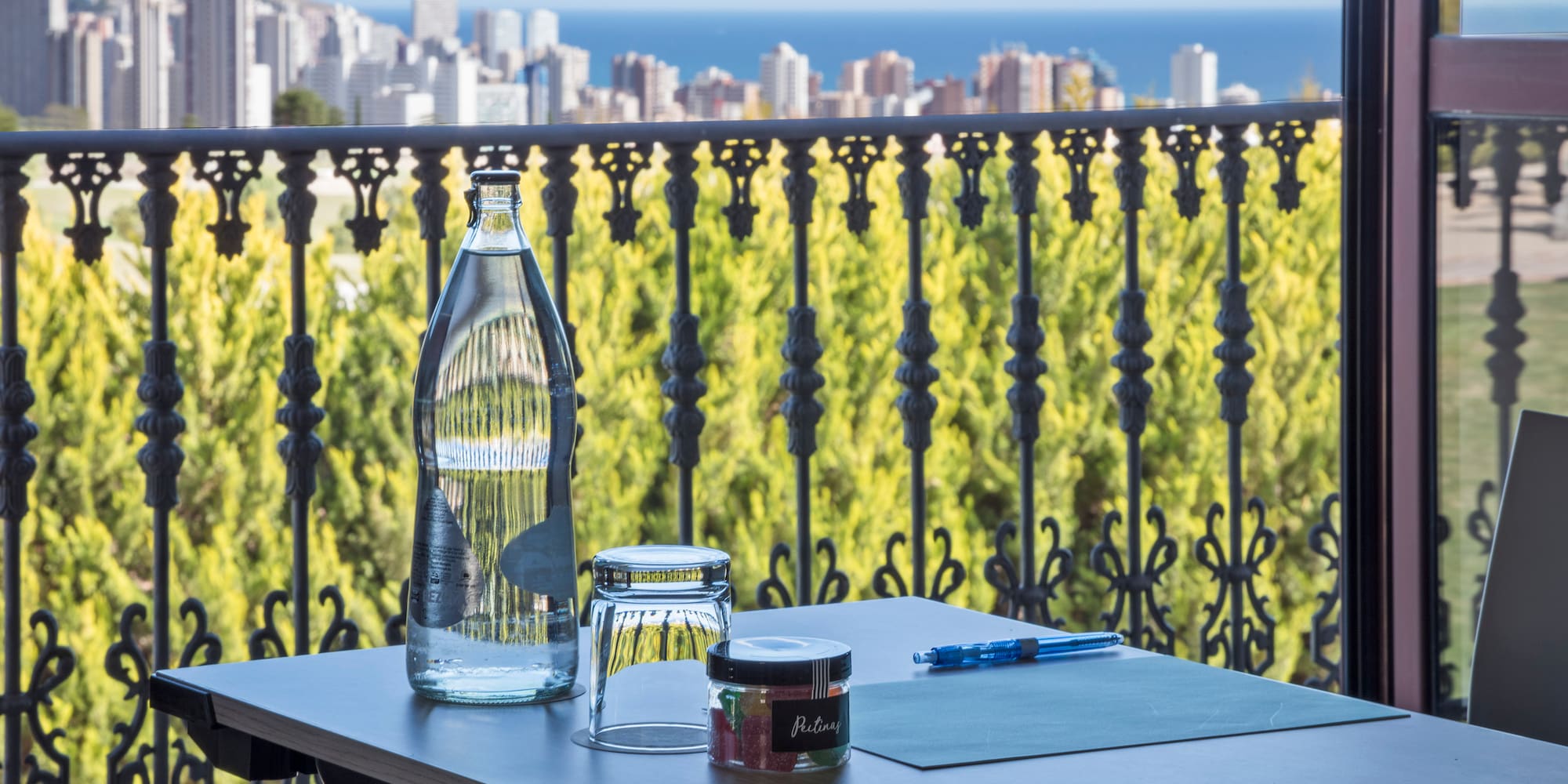 a table with a pen and a bottle on it