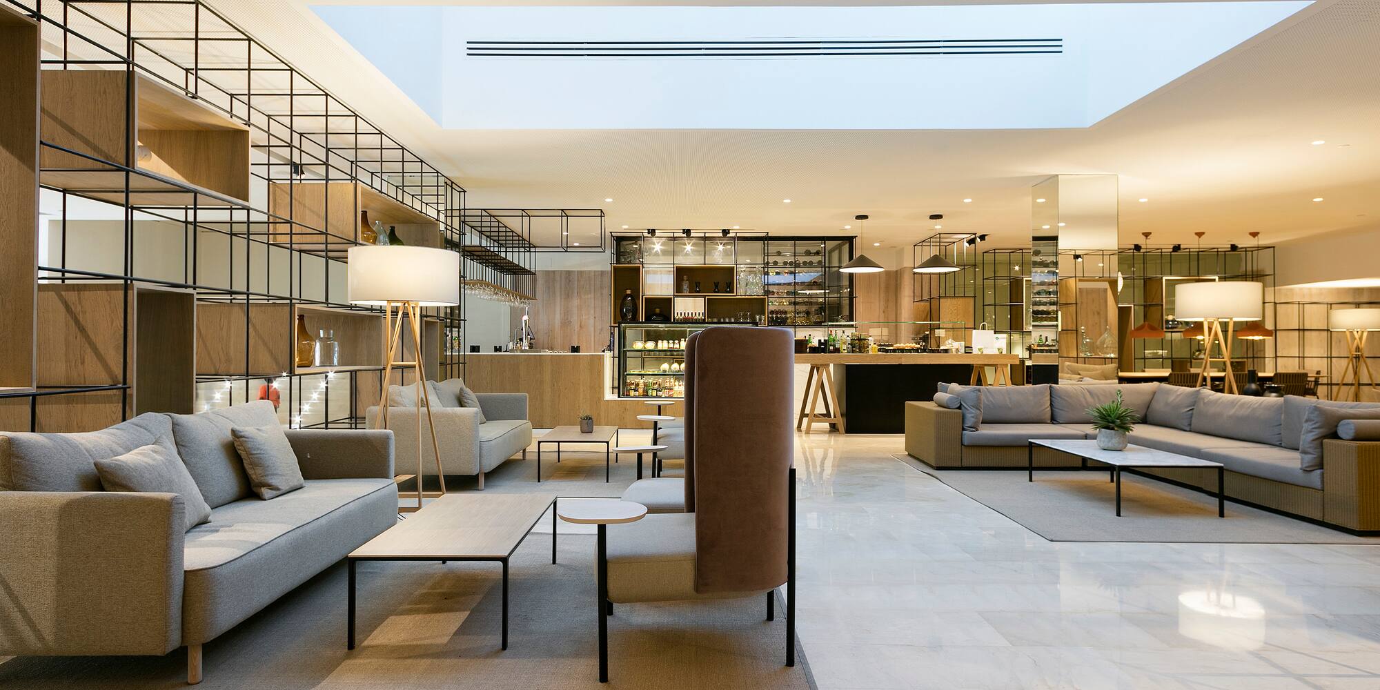 a room with a large couch and tables