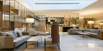 a room with a large couch and tables