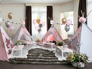 a room with a tent and balloons