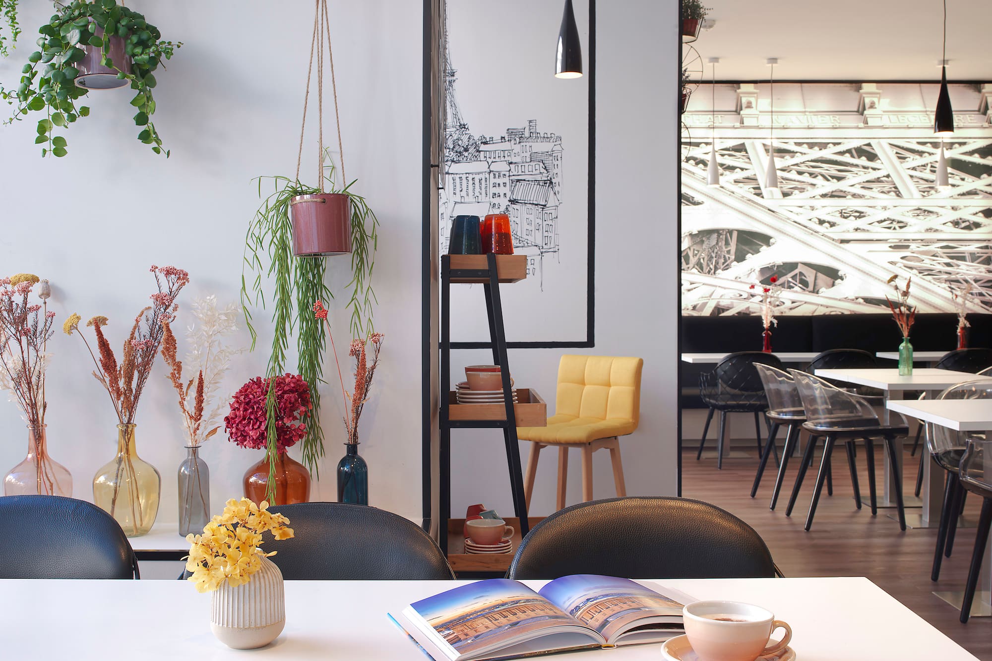 a table with a book and vases of flowers
