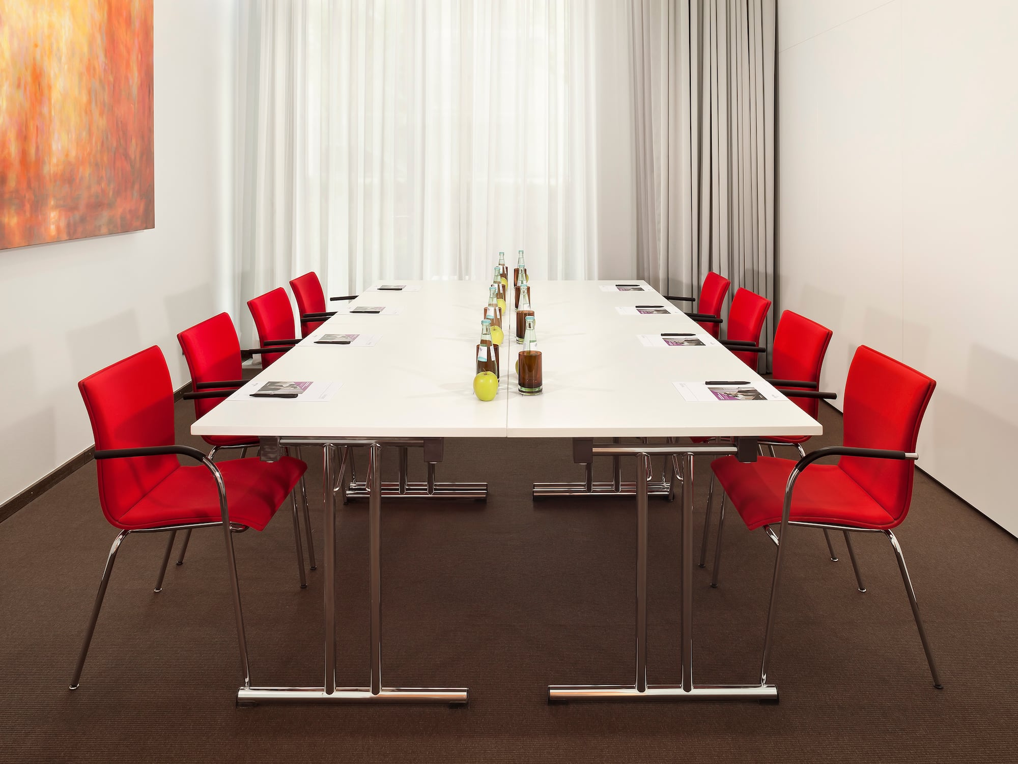 a table with red chairs and bottles of liquid on it