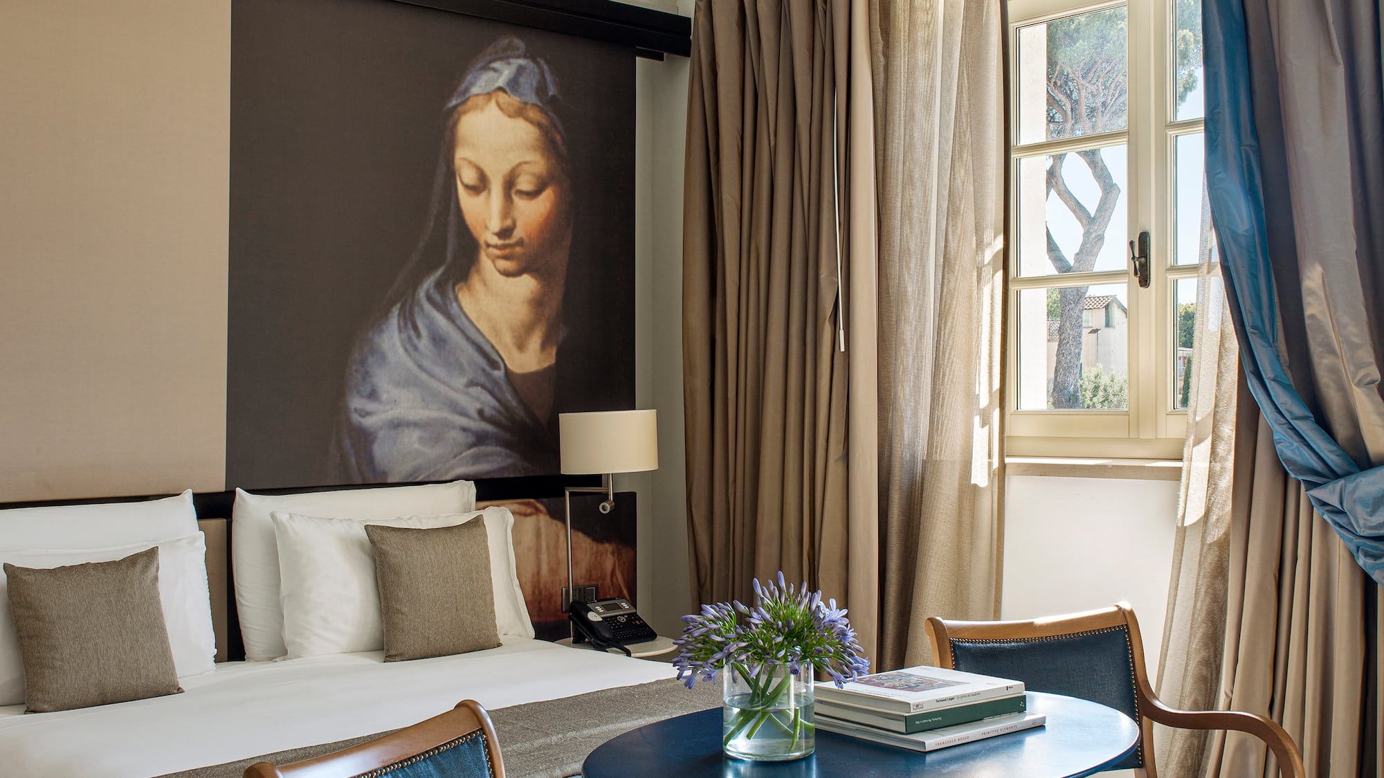 a room with a bed and a table and chairs