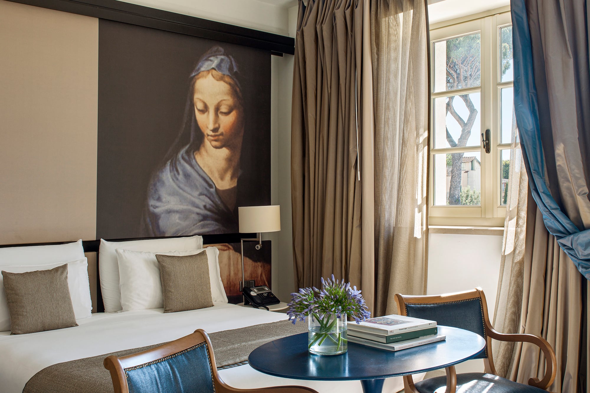 a room with a bed and a table and chairs