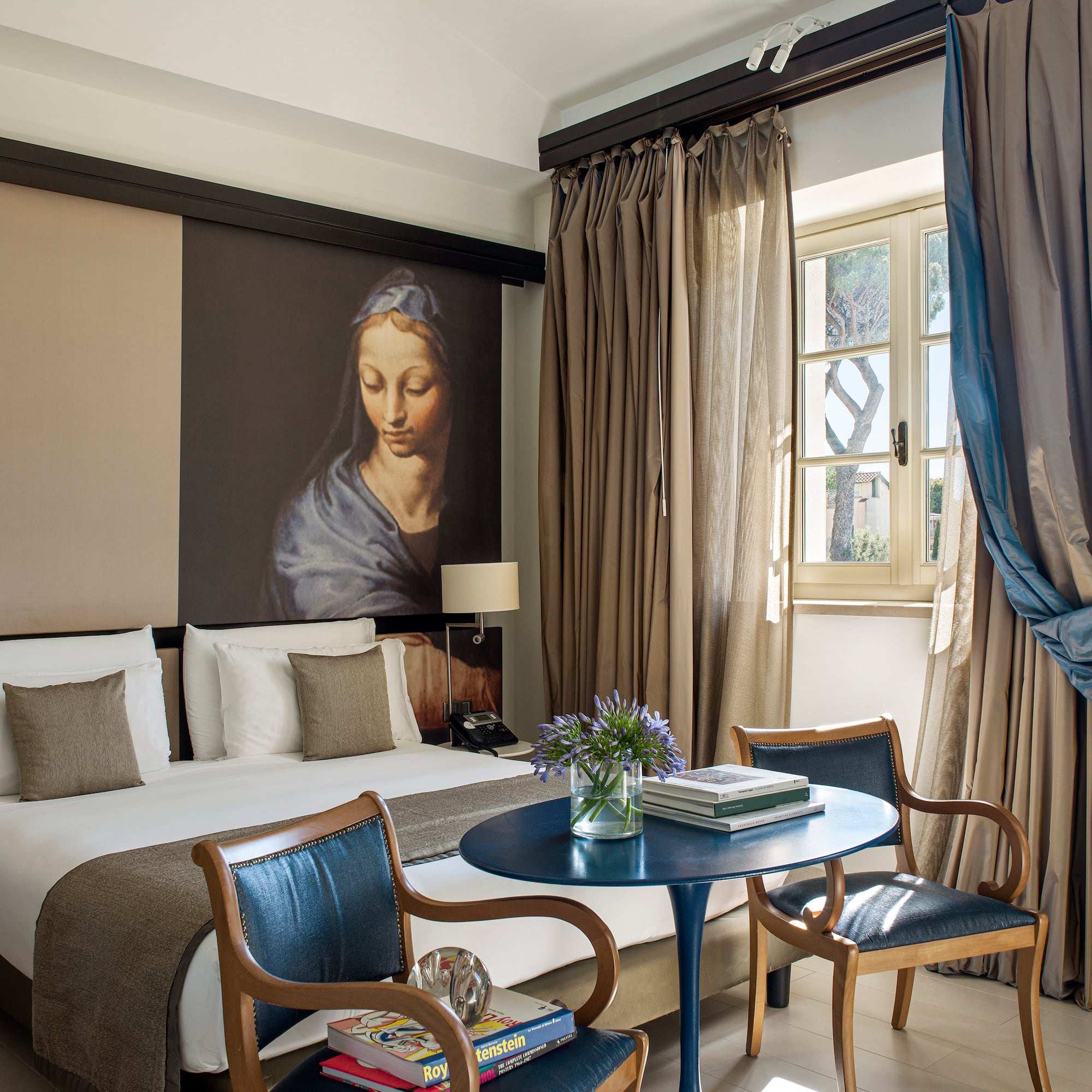 a room with a bed and a table and chairs