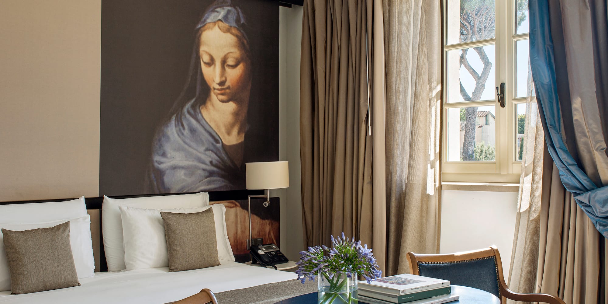 a room with a bed and a table and chairs