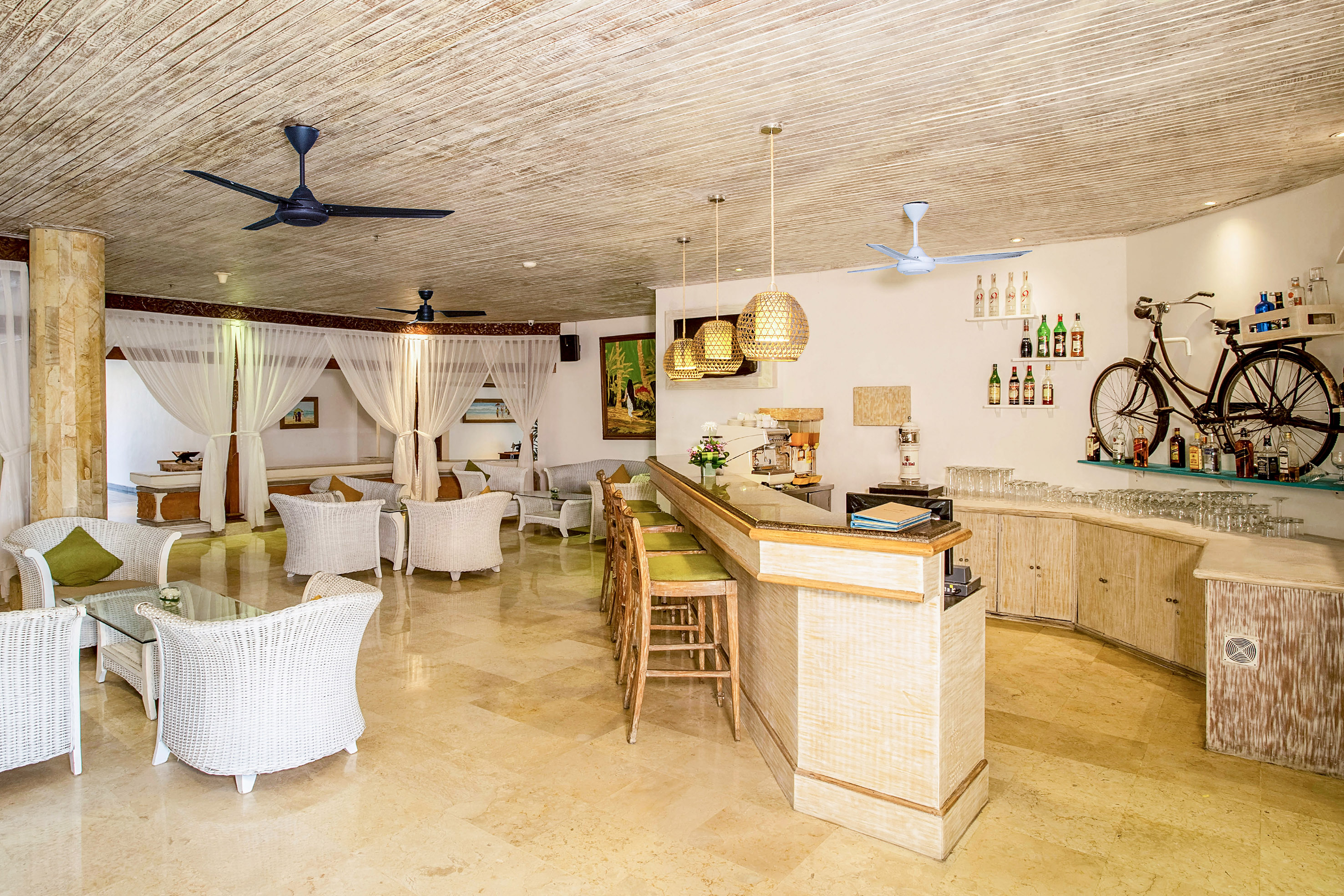 a room with a bar and chairs