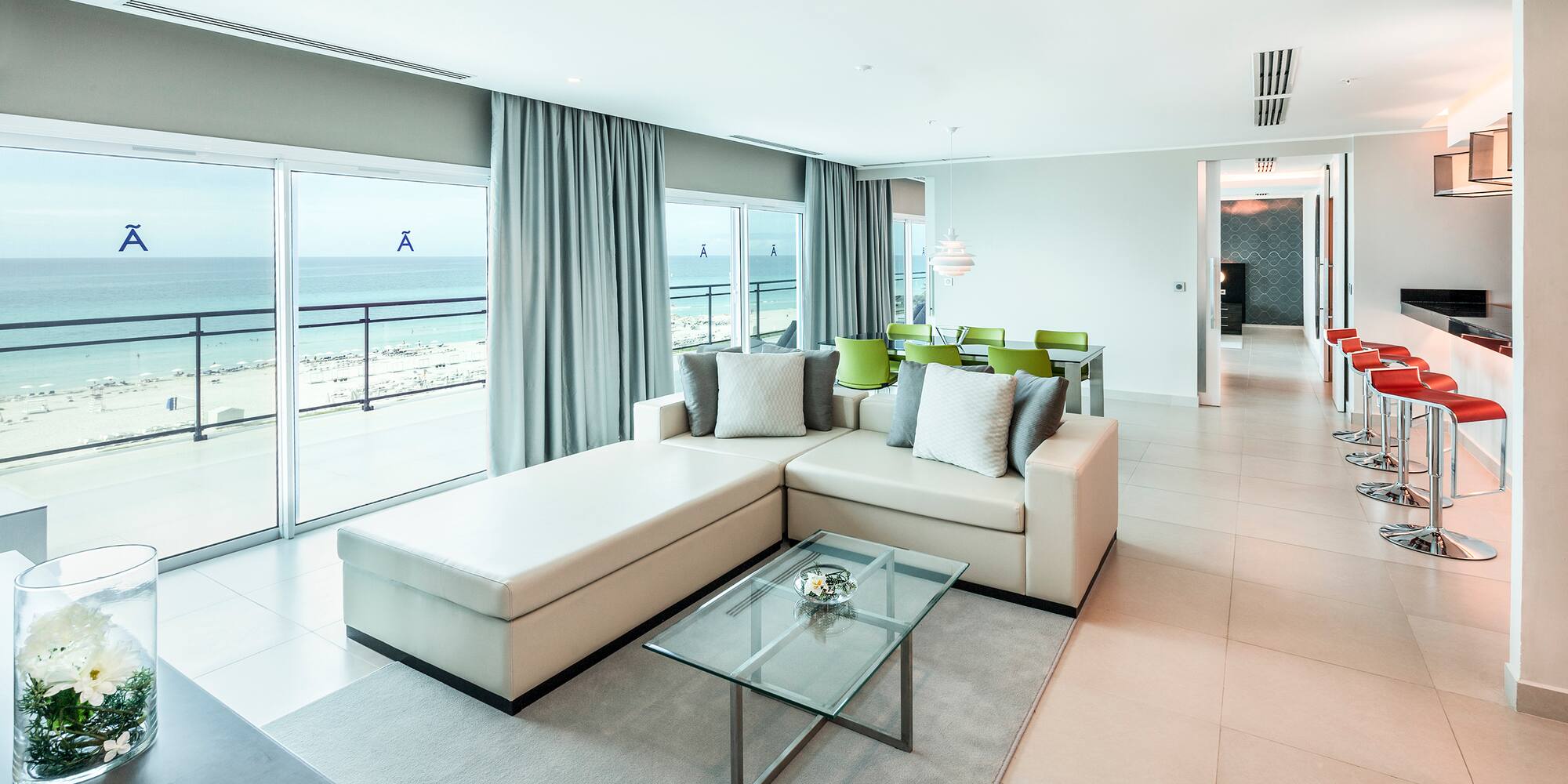 a living room with a large glass table and couch