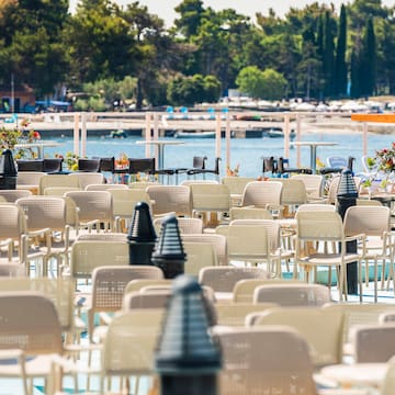 a group of chairs and tables outside