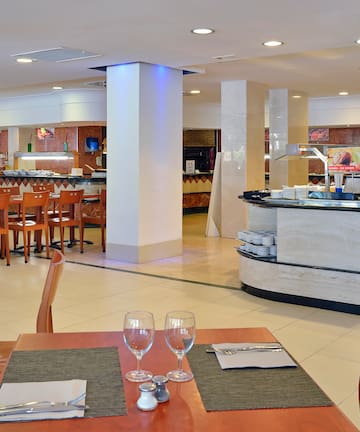 a restaurant with a buffet and wine glasses