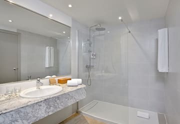 a bathroom with a shower and sink