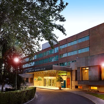 a building with a driveway and trees