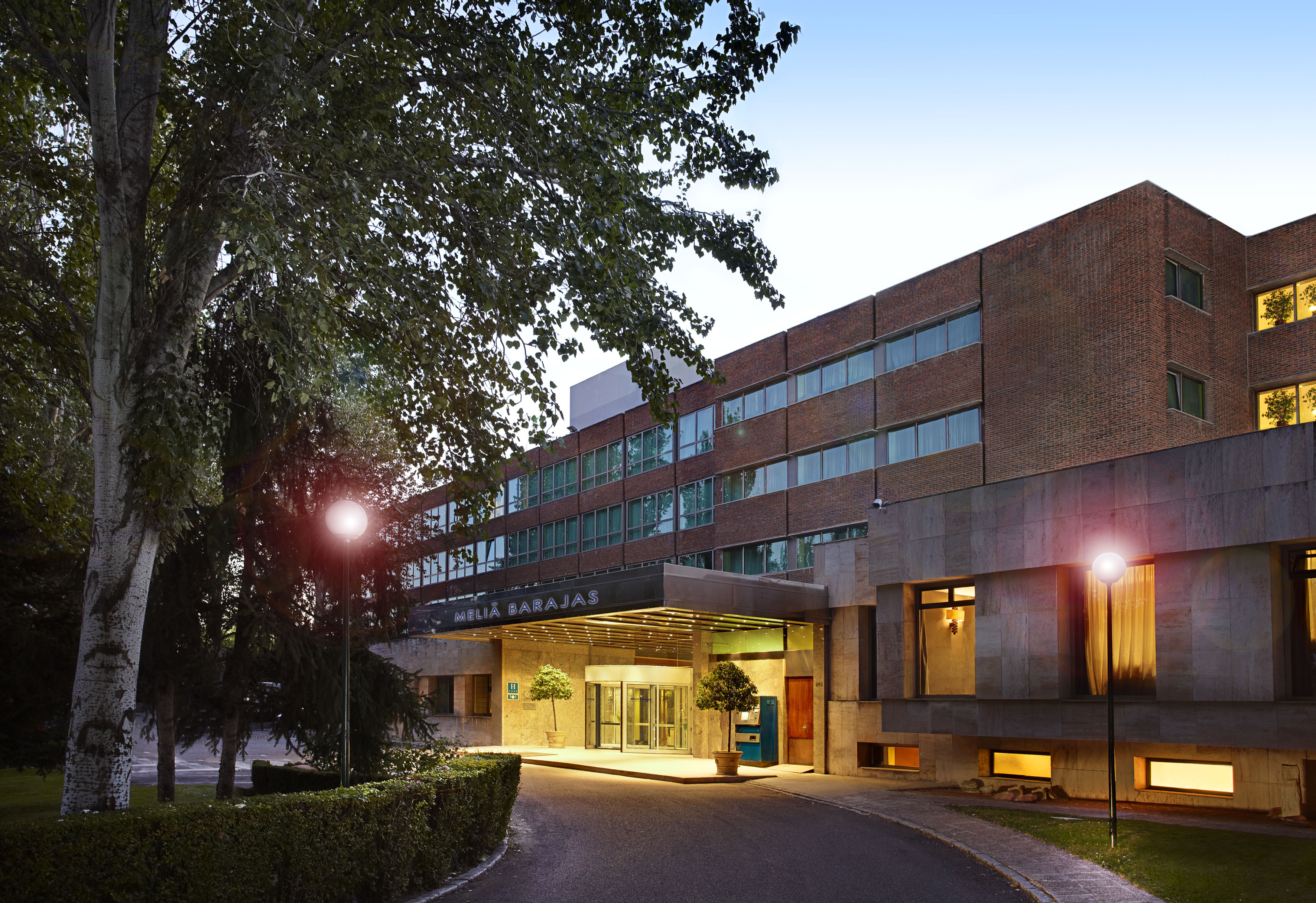 Meliá Barajas hotel exterior, entrance, and driveway at dusk.