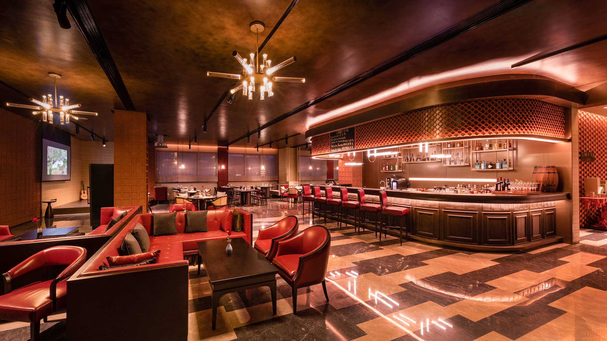 a room with a bar and tables and chairs