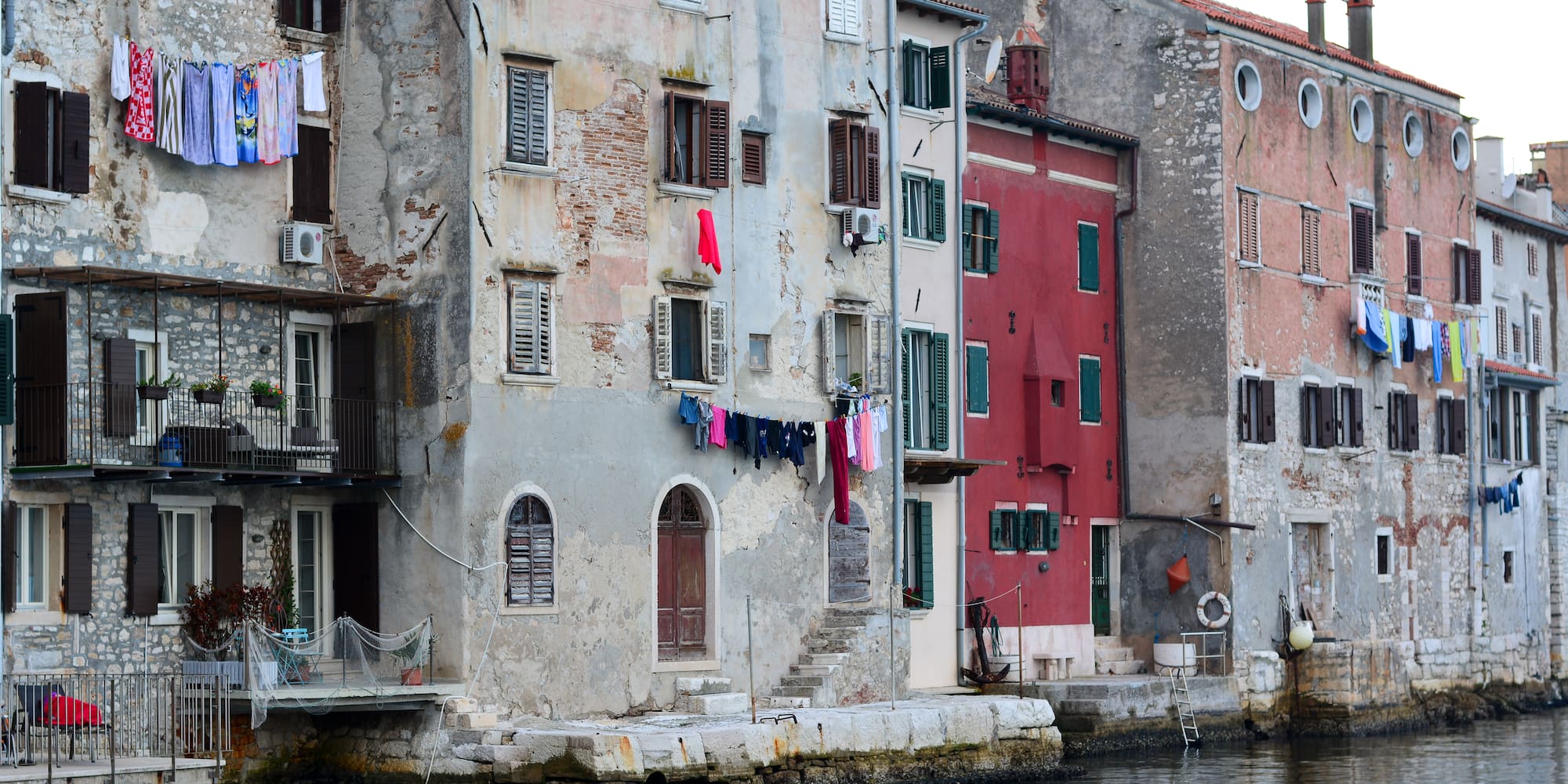 a row of buildings by a body of water