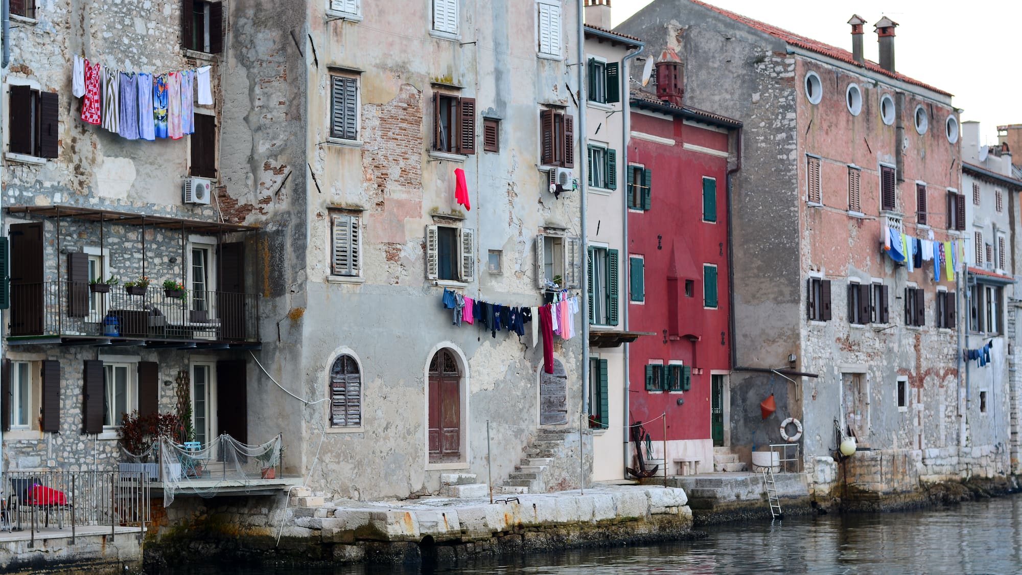 a row of buildings by a body of water