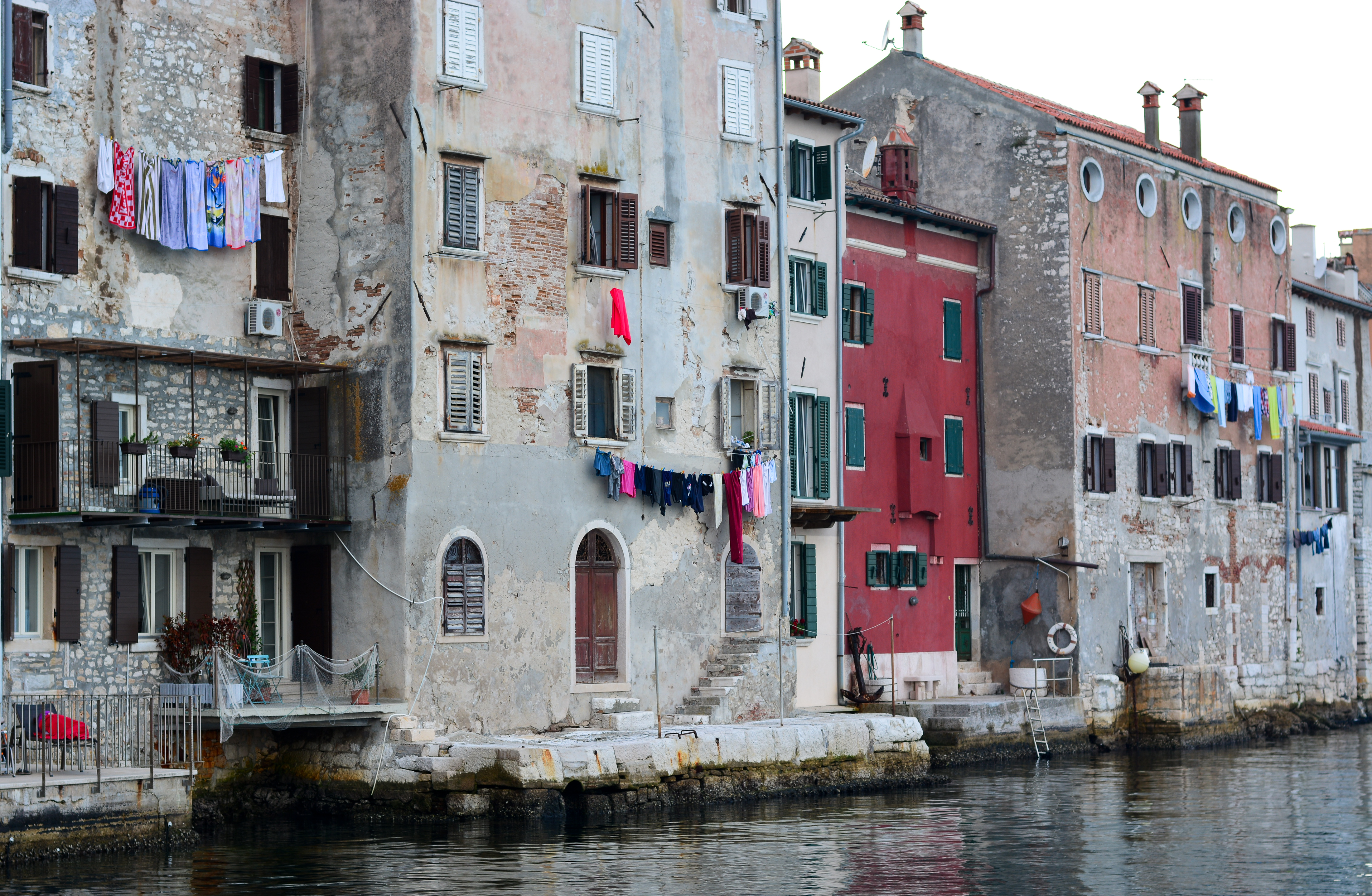 a row of buildings by a body of water