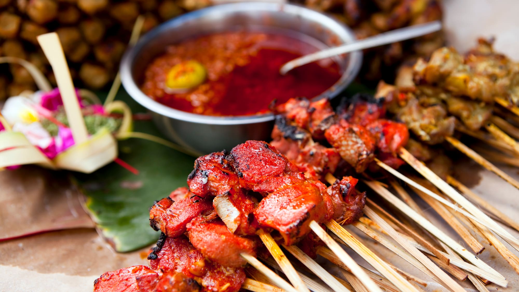 a group of skewers of meat and sauce
