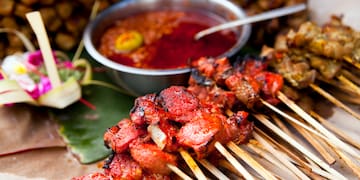 a group of skewers of meat and sauce