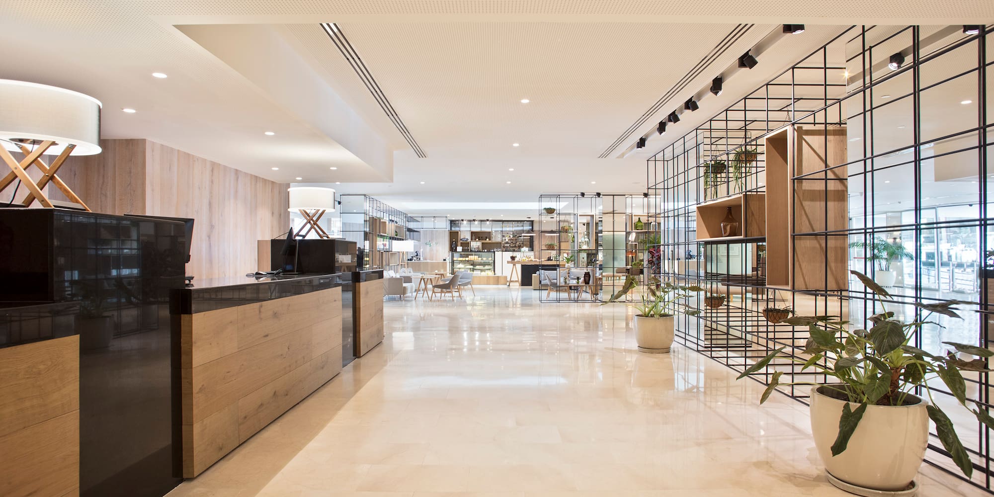 a lobby with a reception desk and plants