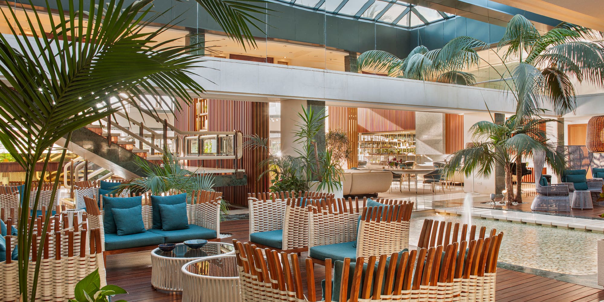 a room with a pool and a large glass ceiling