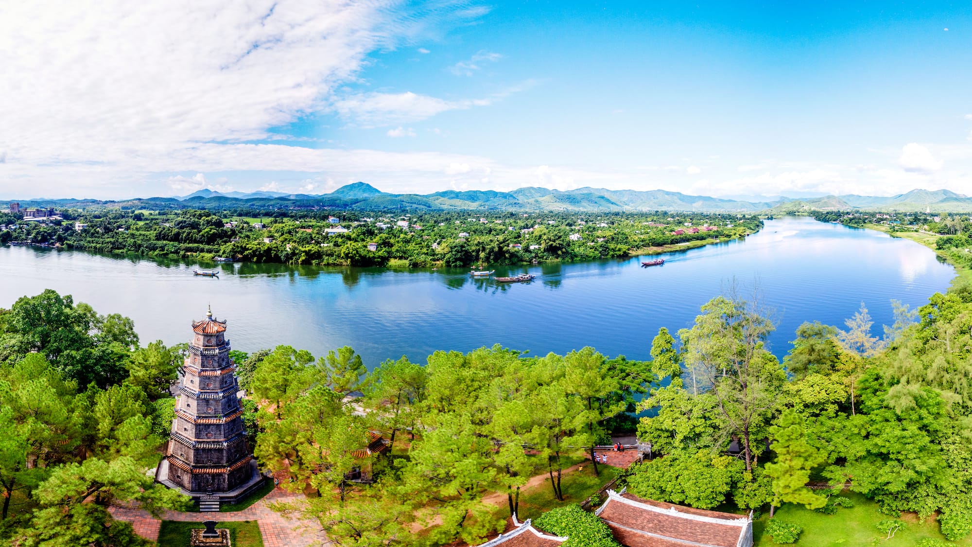 a body of water with trees and buildings
