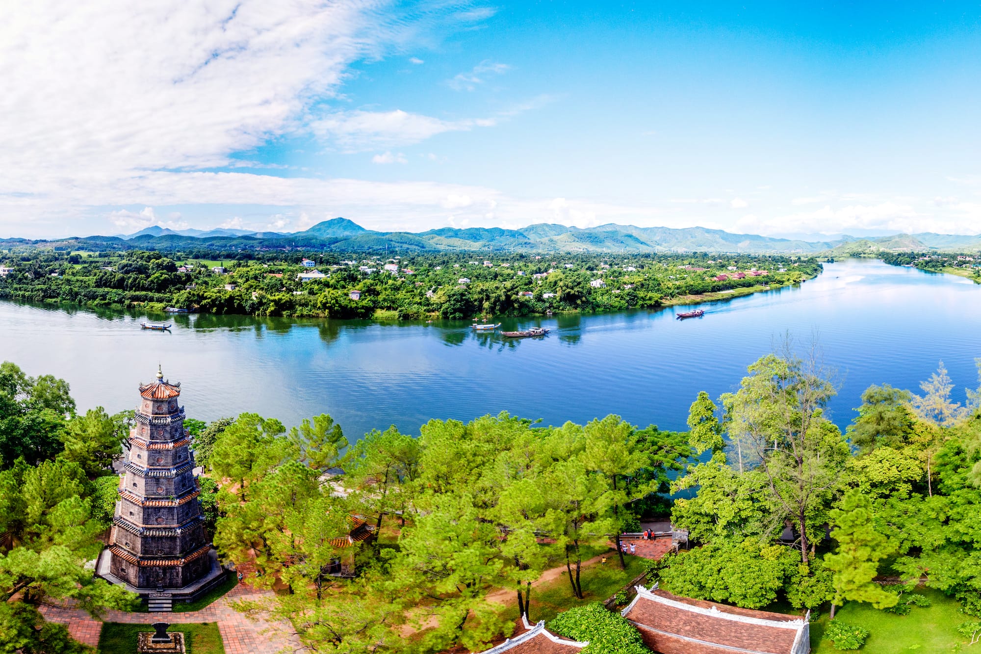 a body of water with trees and buildings