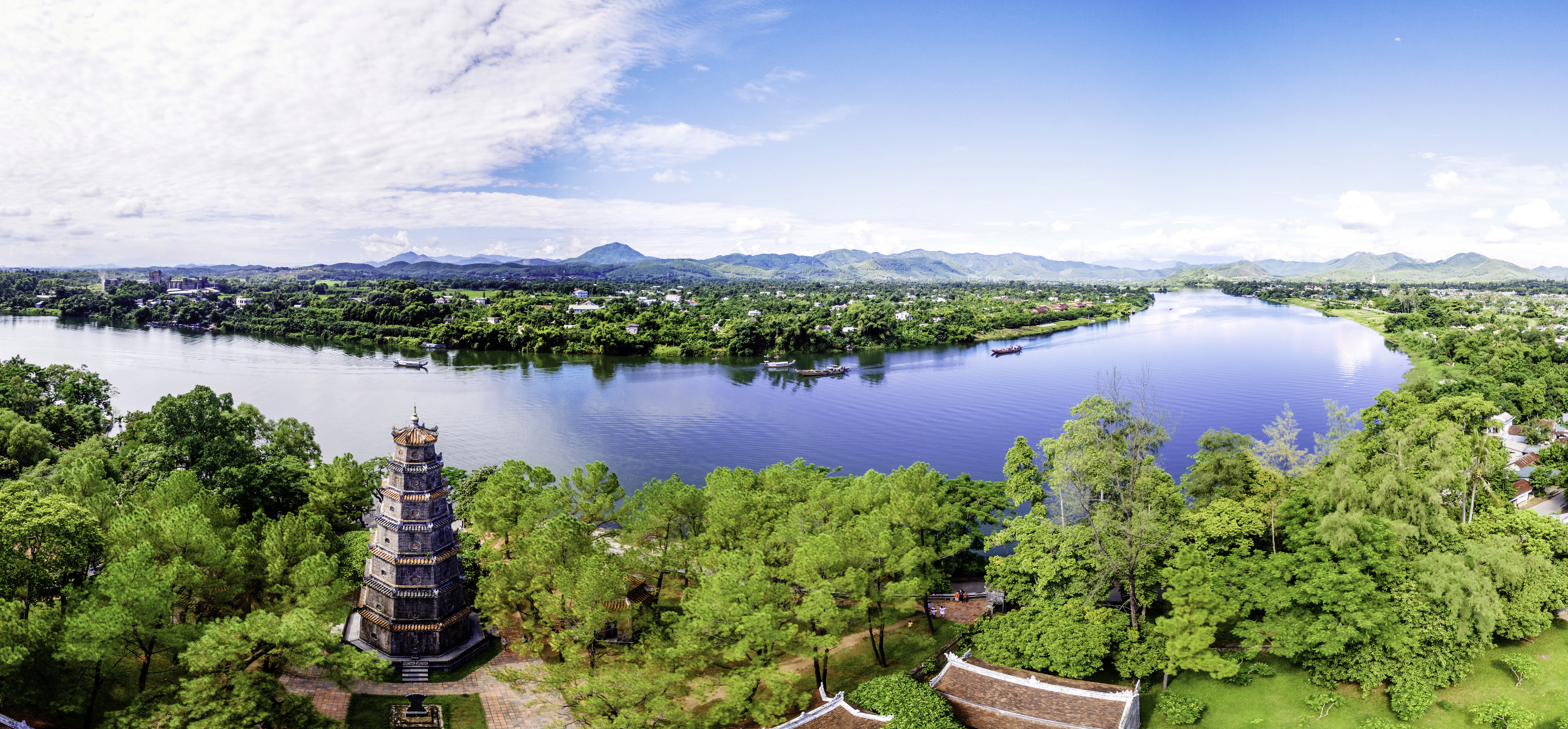a body of water with trees and buildings