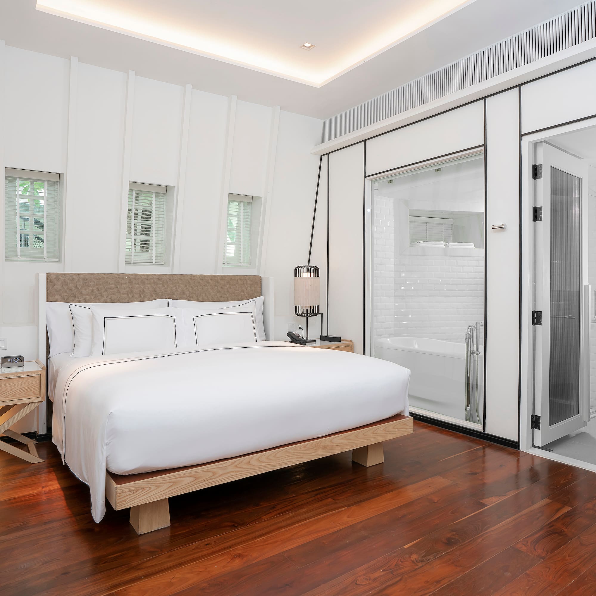 a bedroom with a bed and a wood floor