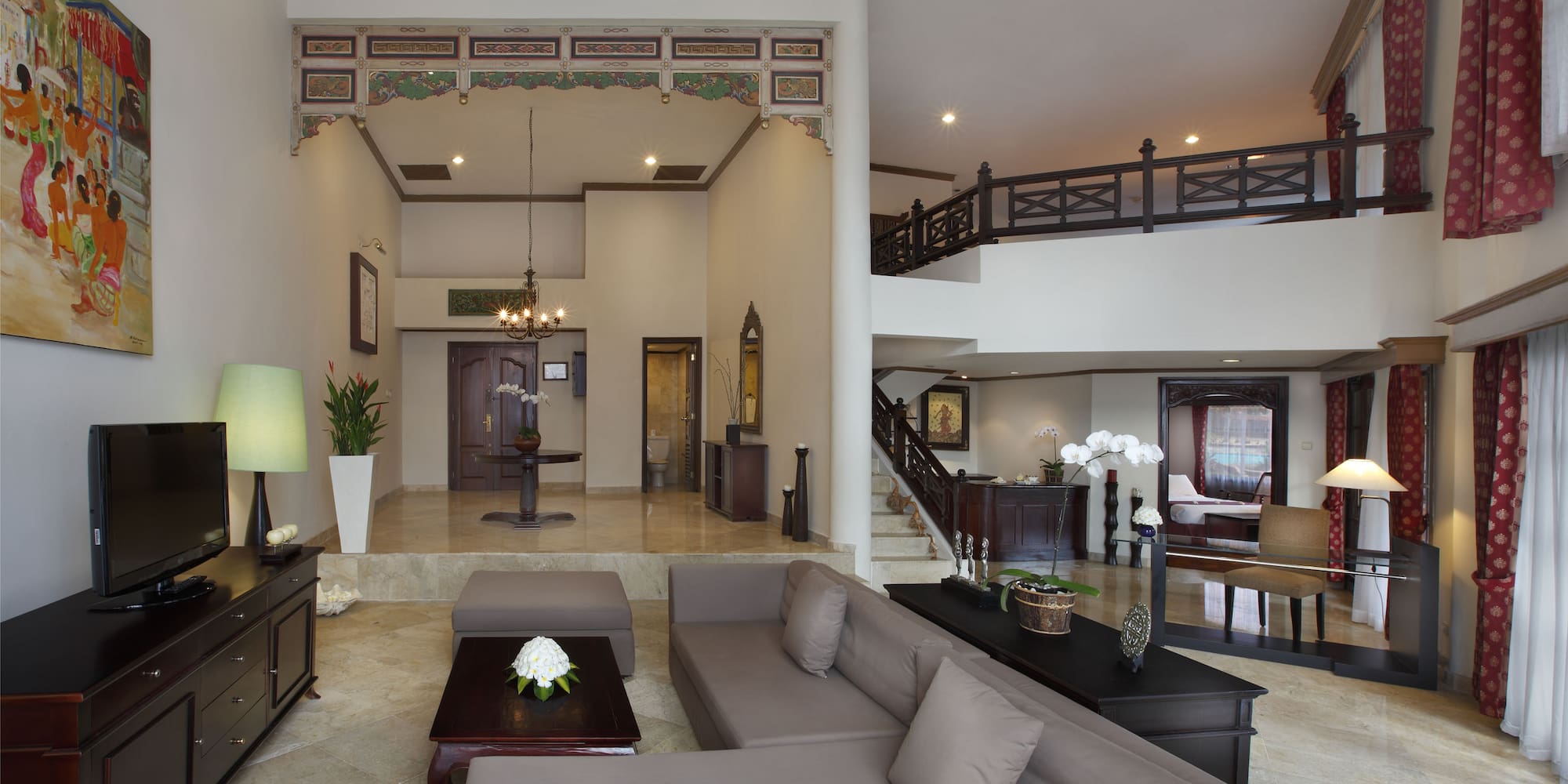 a living room with a large couch and a large staircase