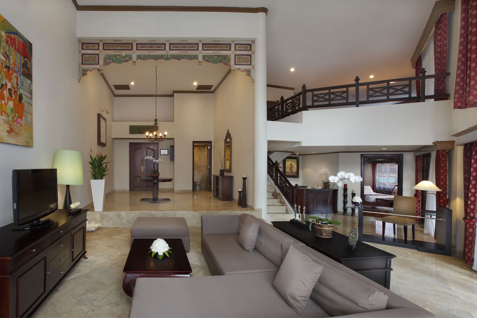 a living room with a large couch and a large staircase