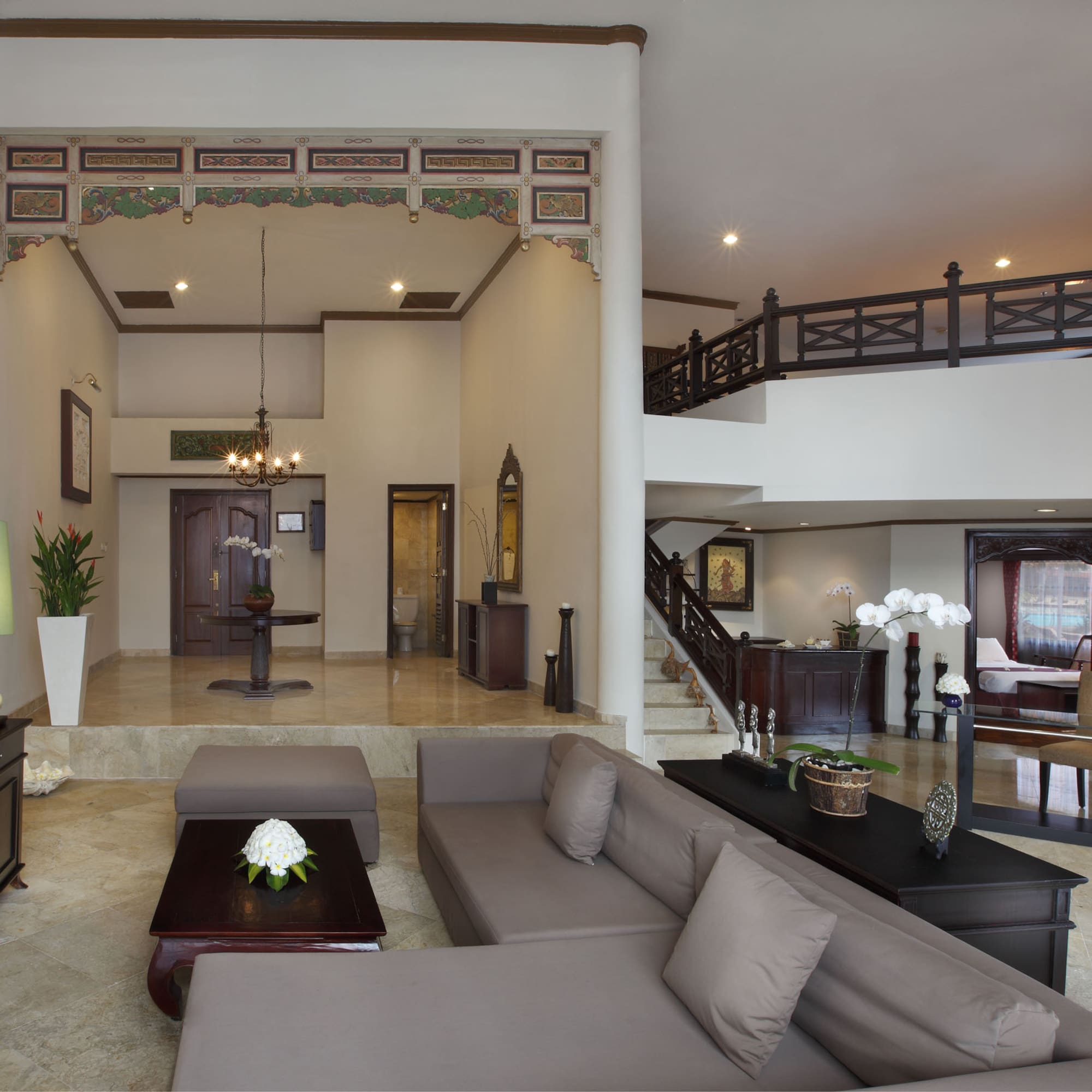 a living room with a large couch and a large staircase