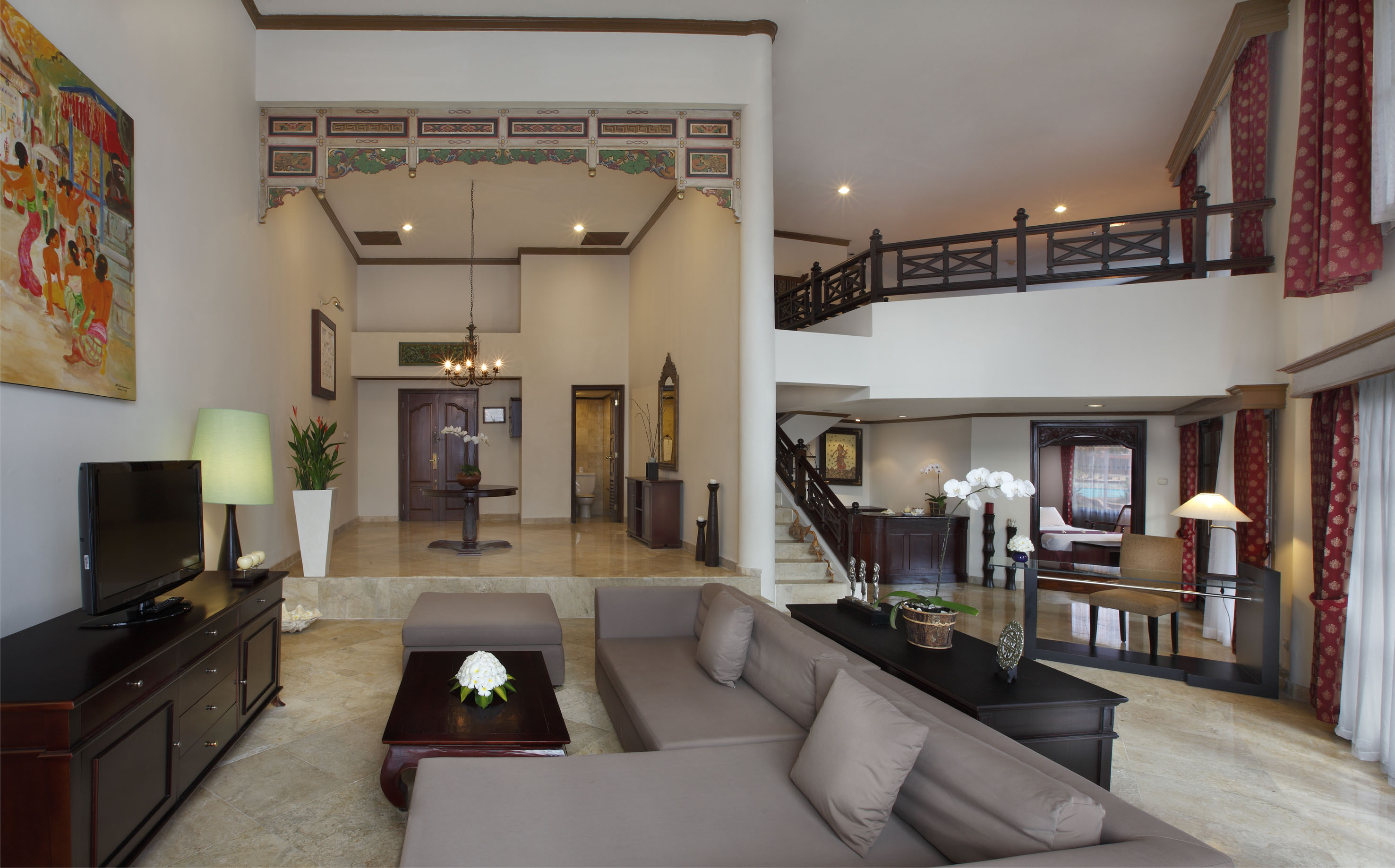 a living room with a large couch and a large staircase
