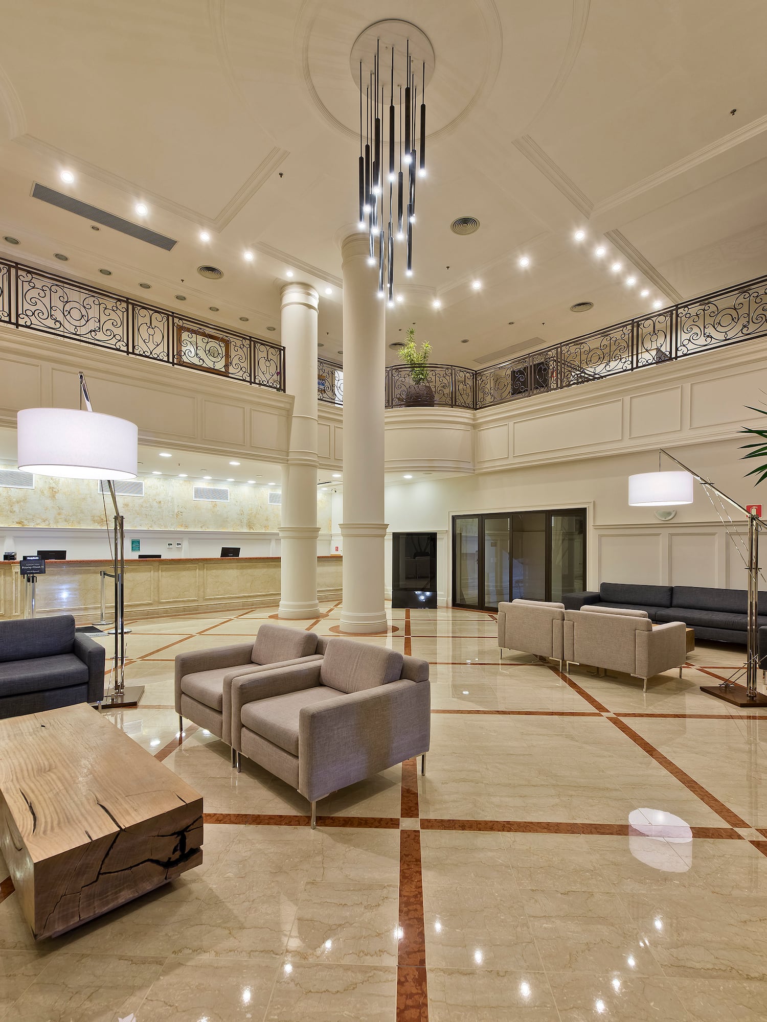 a large room with a large chandelier and couches