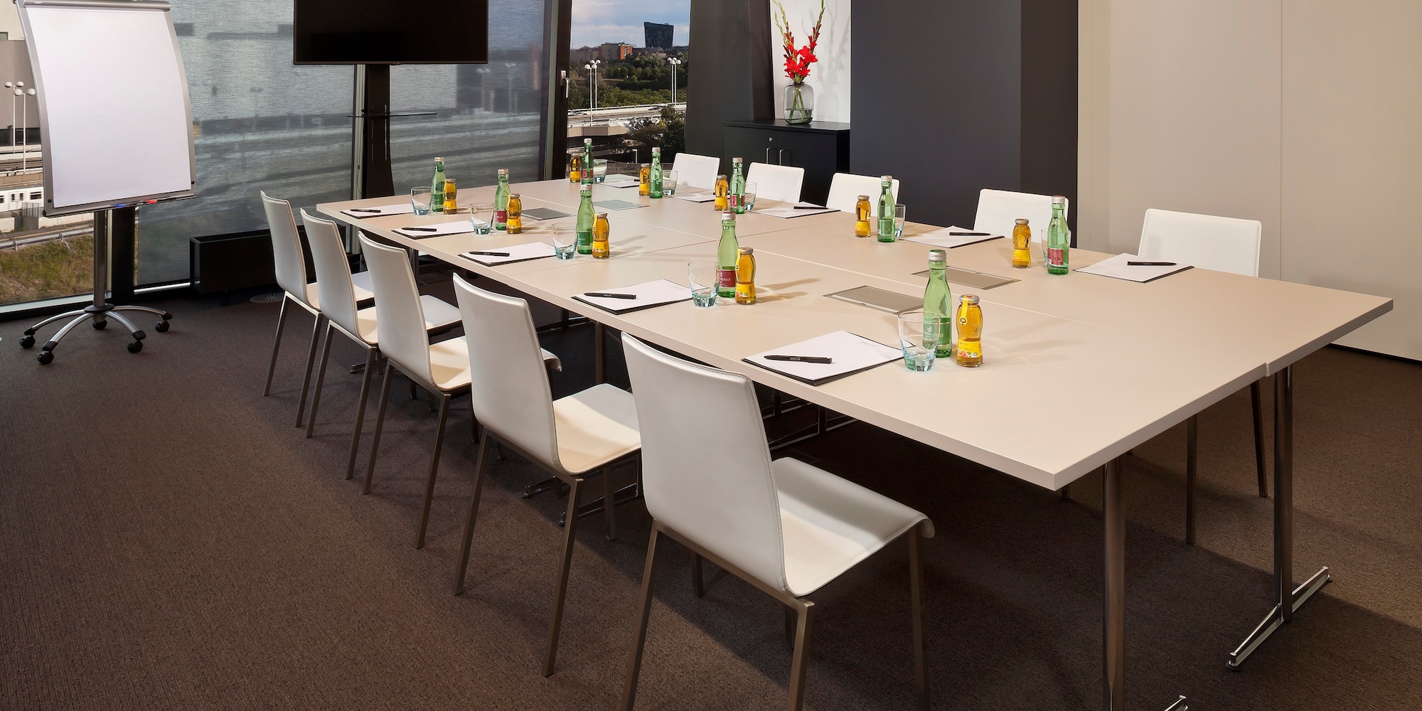 a long conference table with bottles and papers
