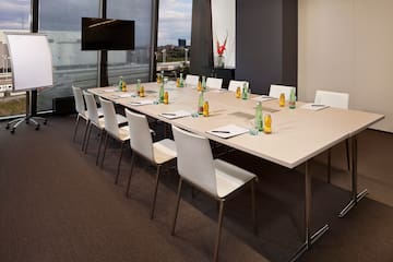 a long conference table with bottles and papers