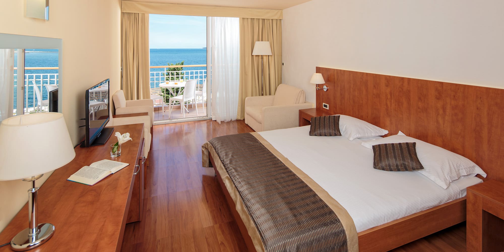 a room with a bed and a television