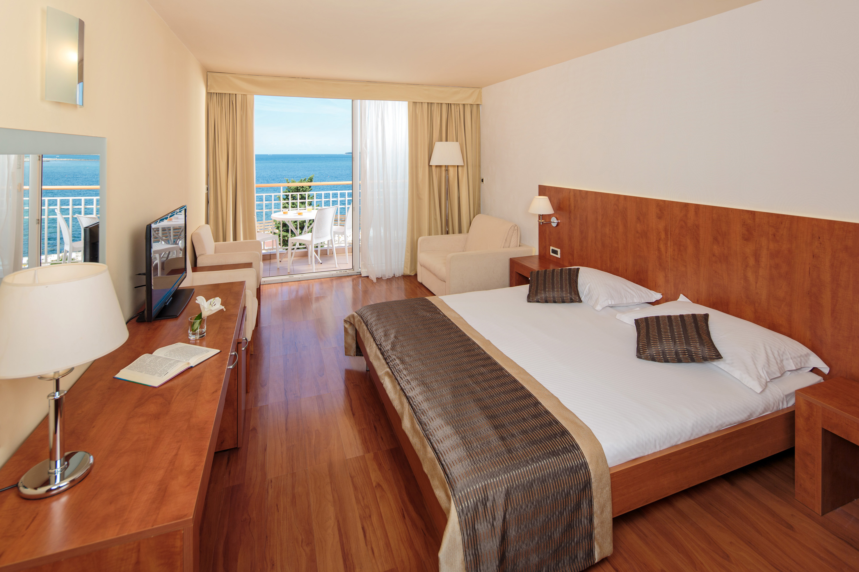 a room with a bed and a television