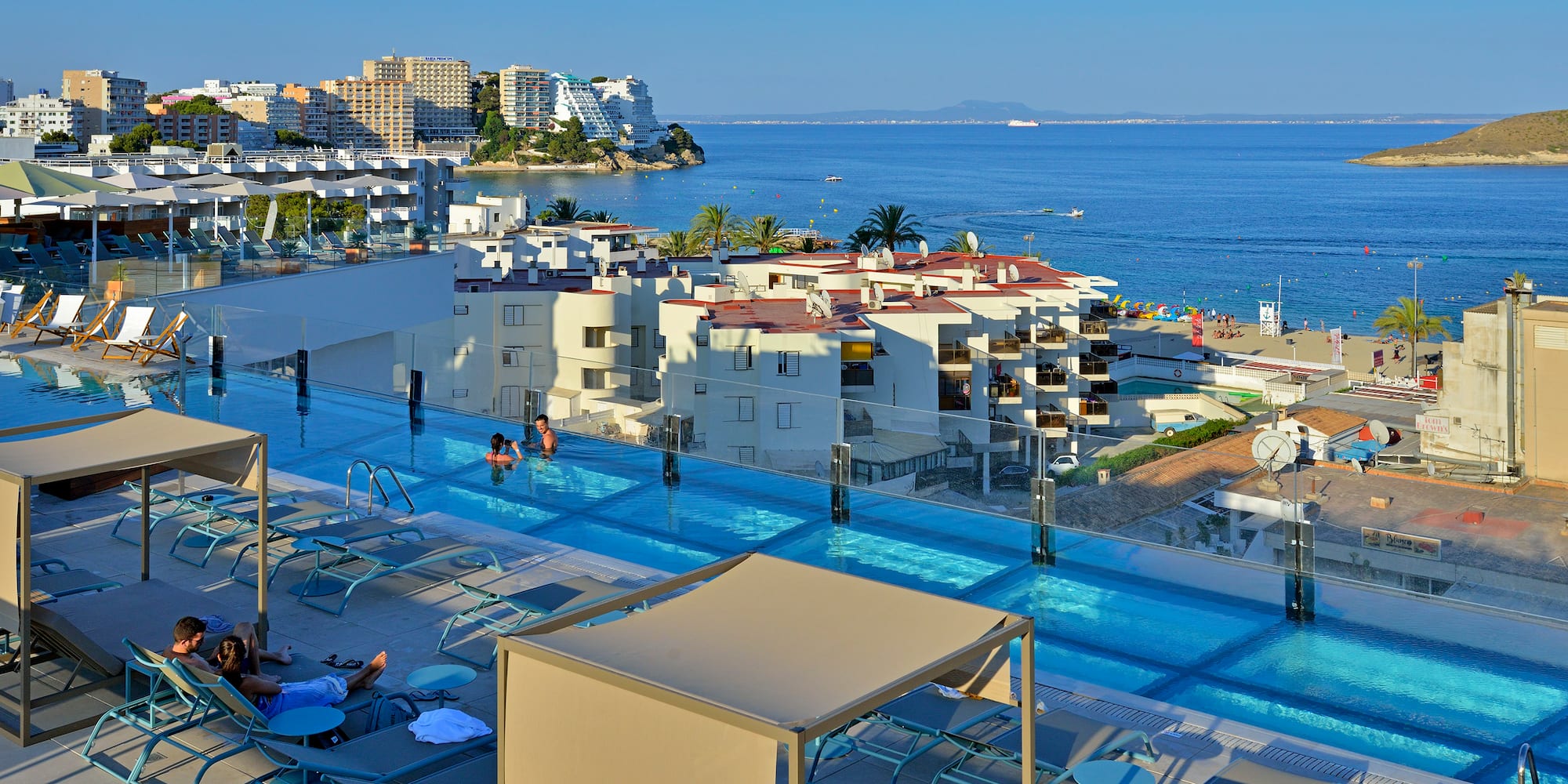 a pool with a body of water and buildings
