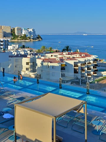 a pool with a body of water and buildings