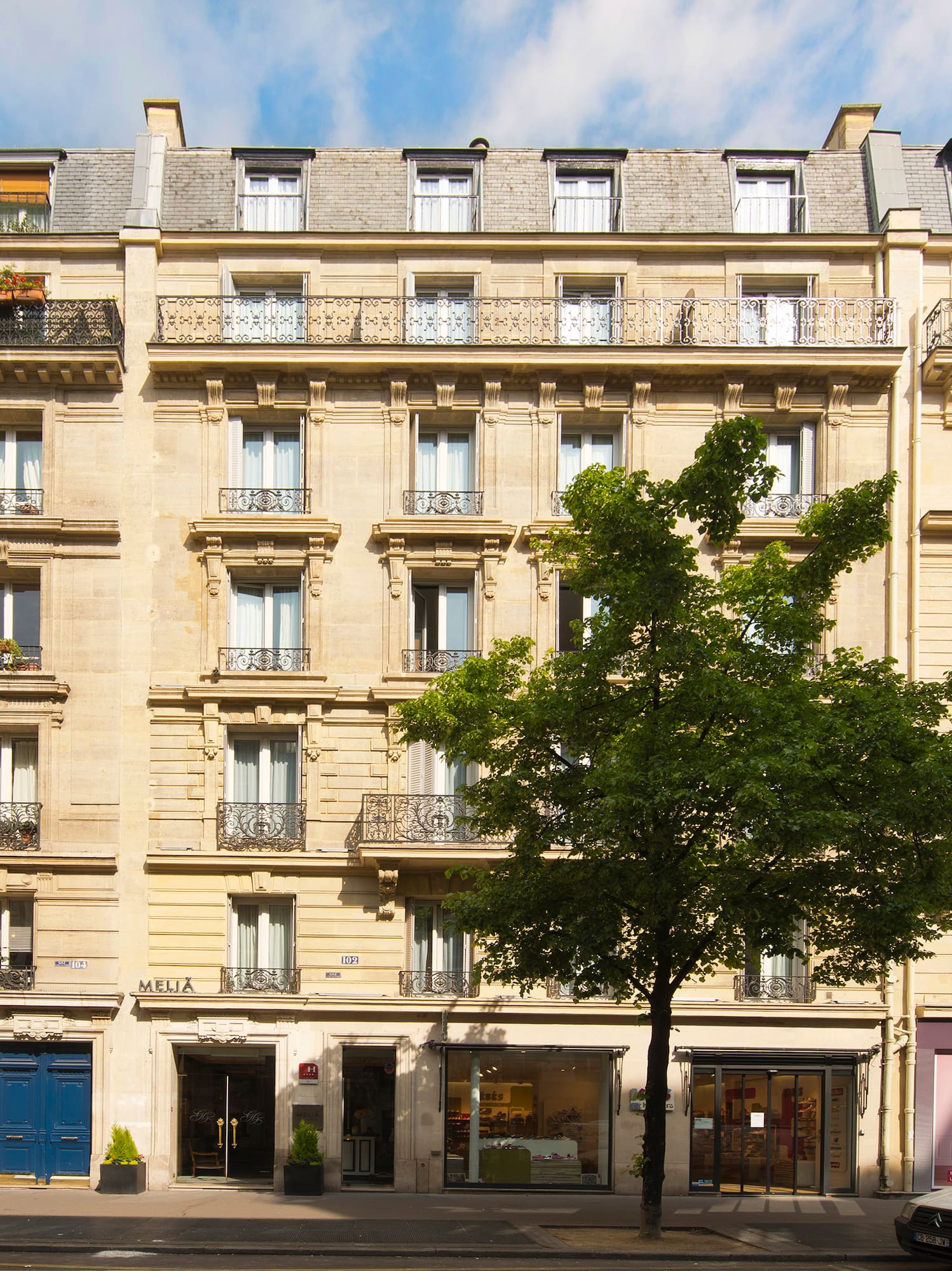a building with many windows and a tree