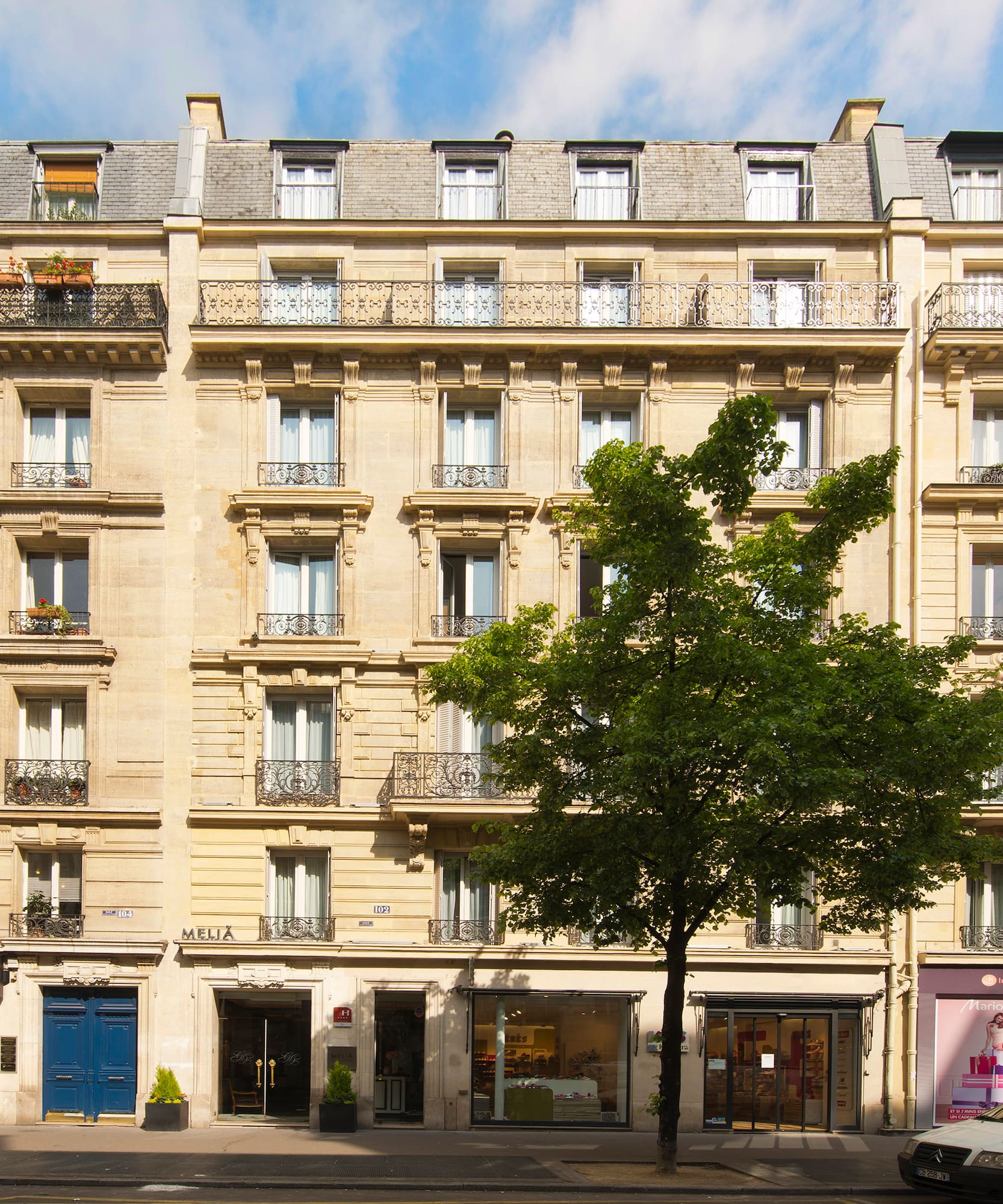 a building with many windows and a tree